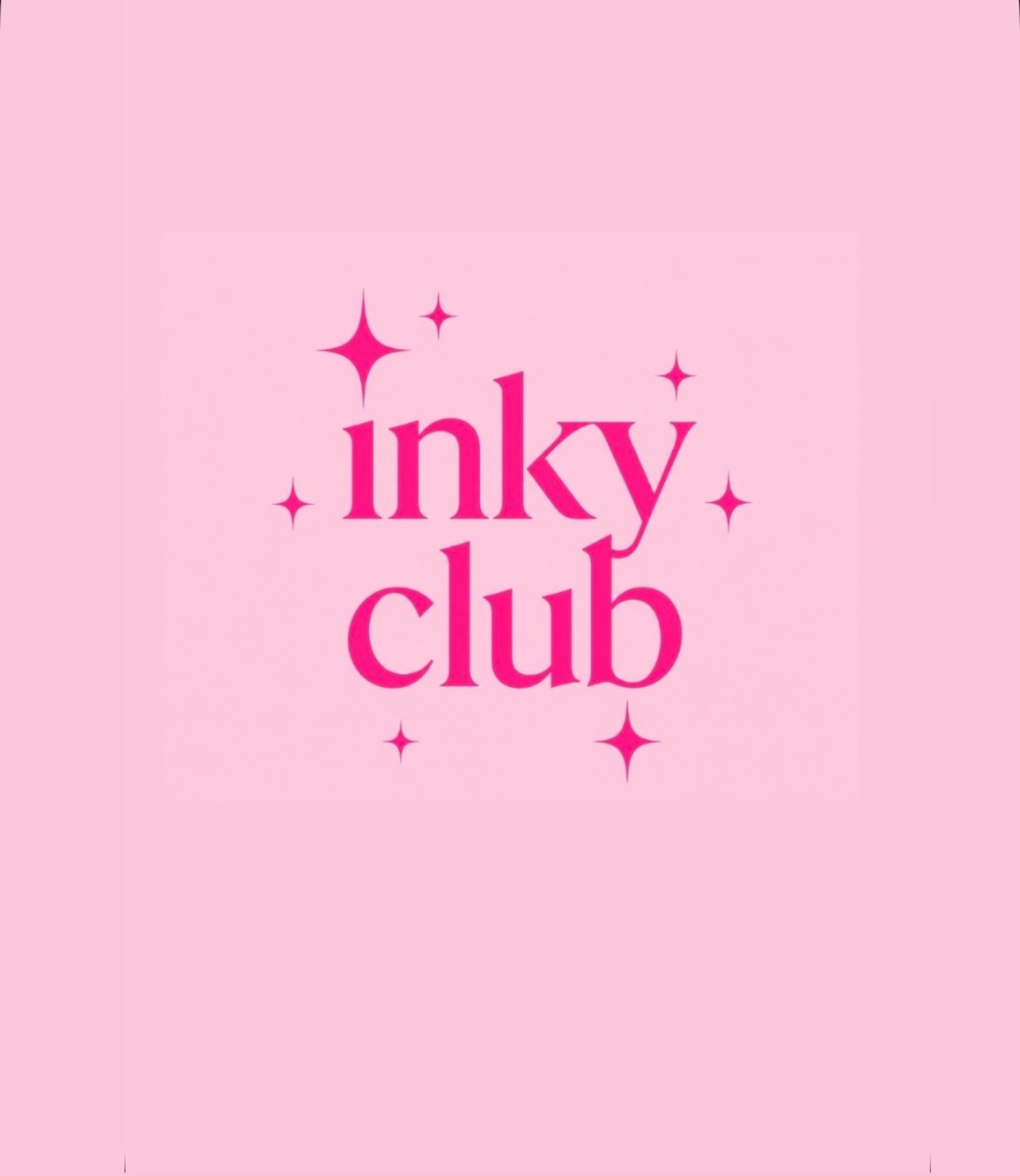The Inky Club sign, pink serif lettering with sparkles, on the studio wall