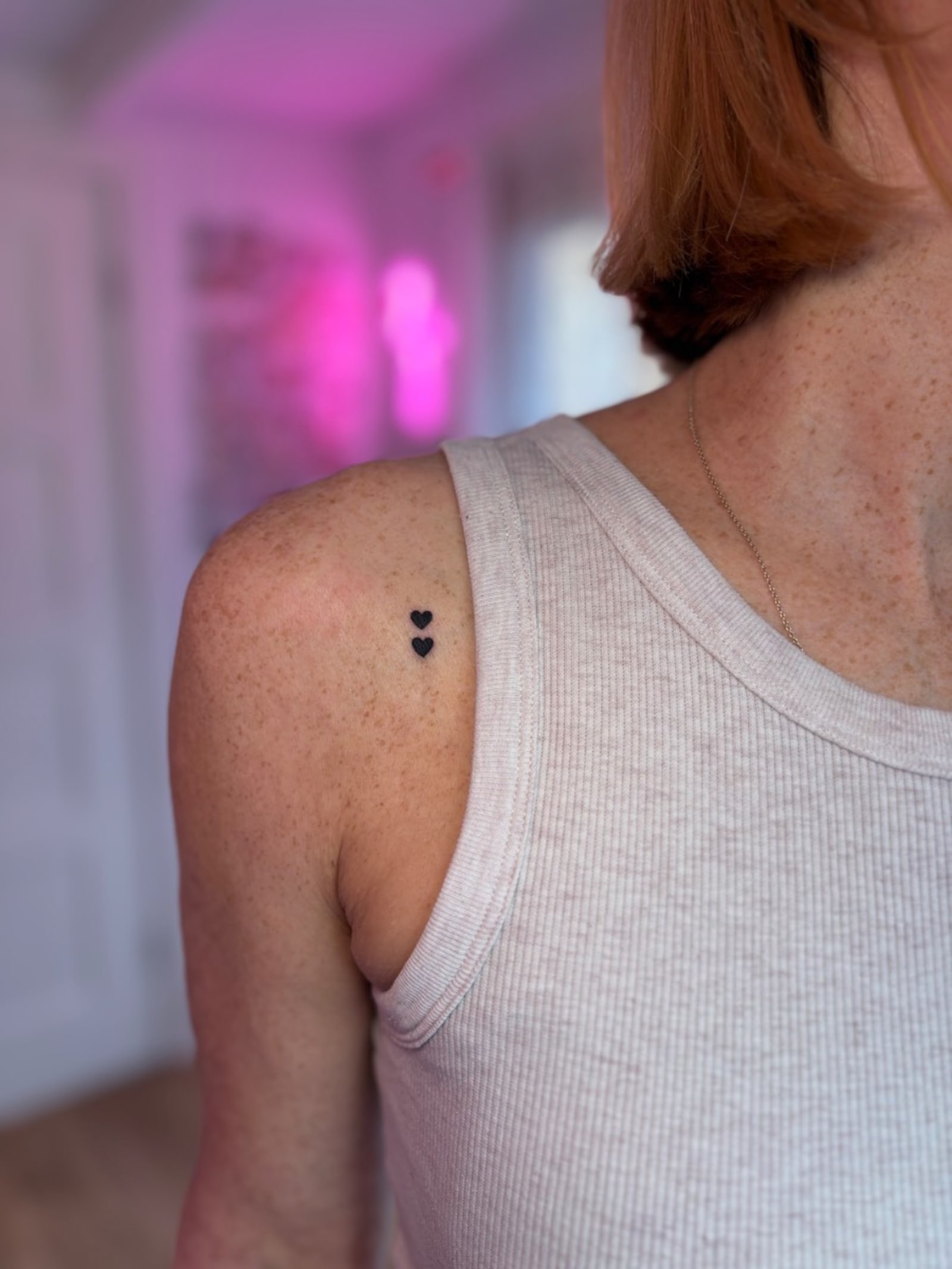 Trio of tiny fine line heart tattoos